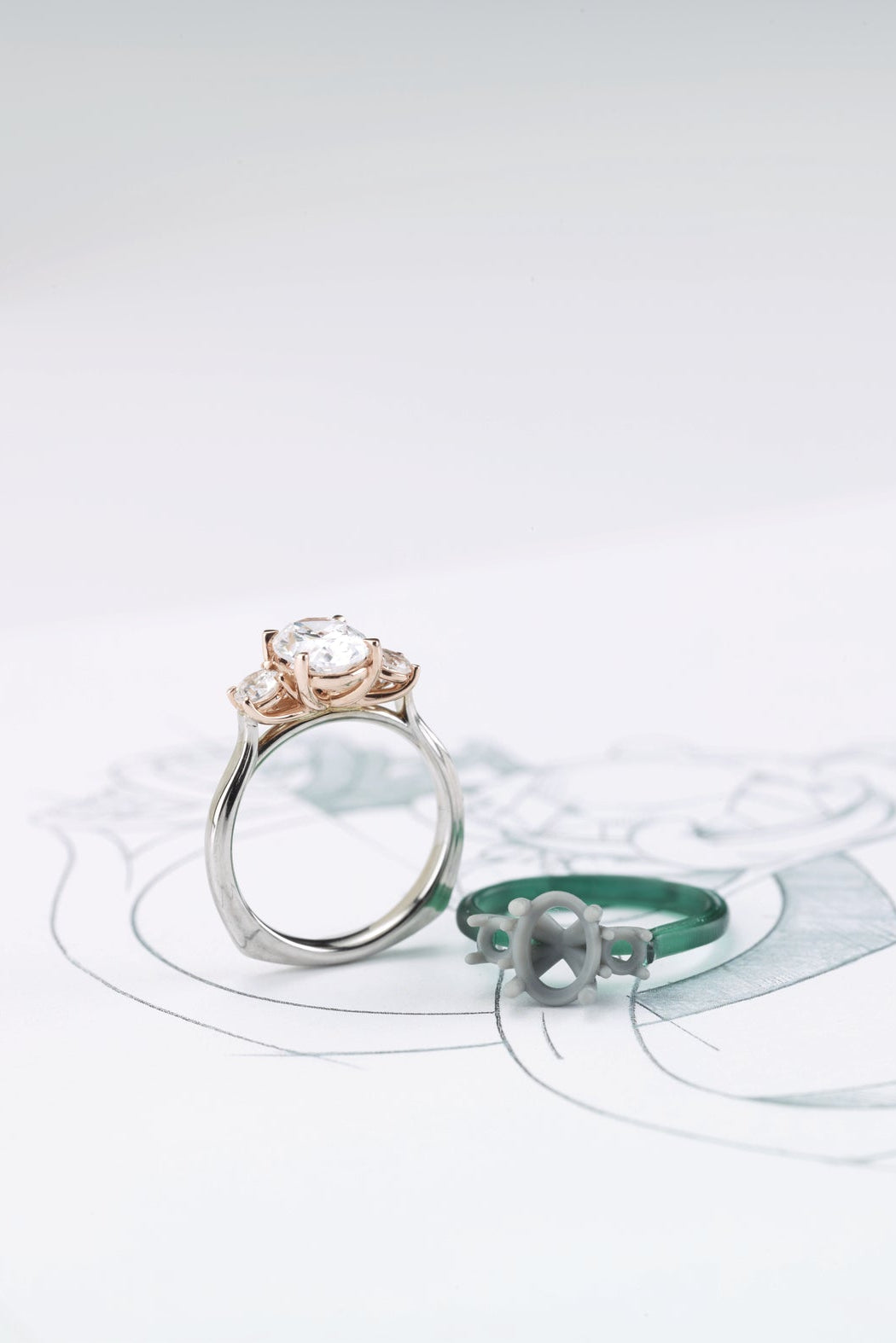 Two rings on a white surface with a light green circular design.