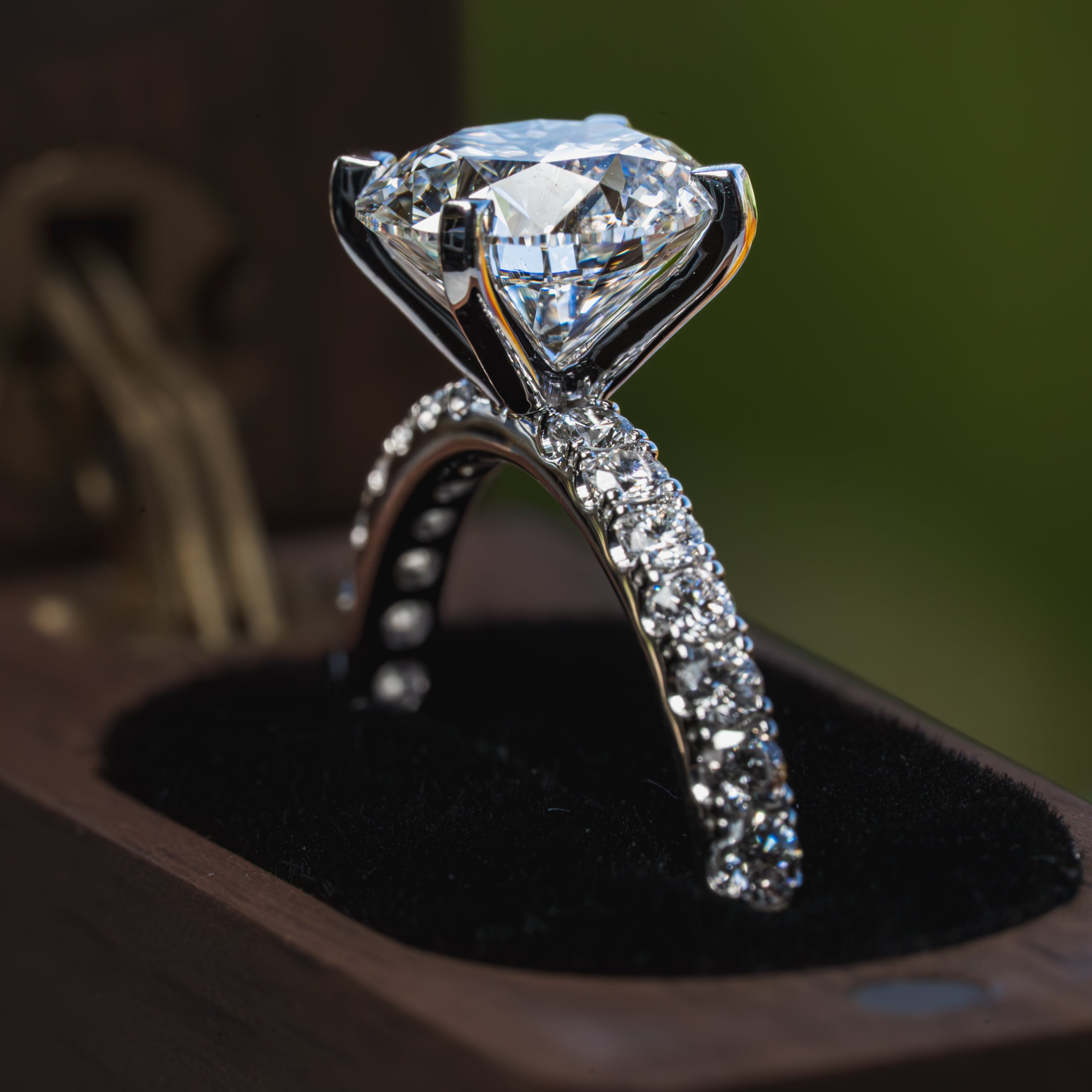 Diamond ring on a black cushion with a blurred background