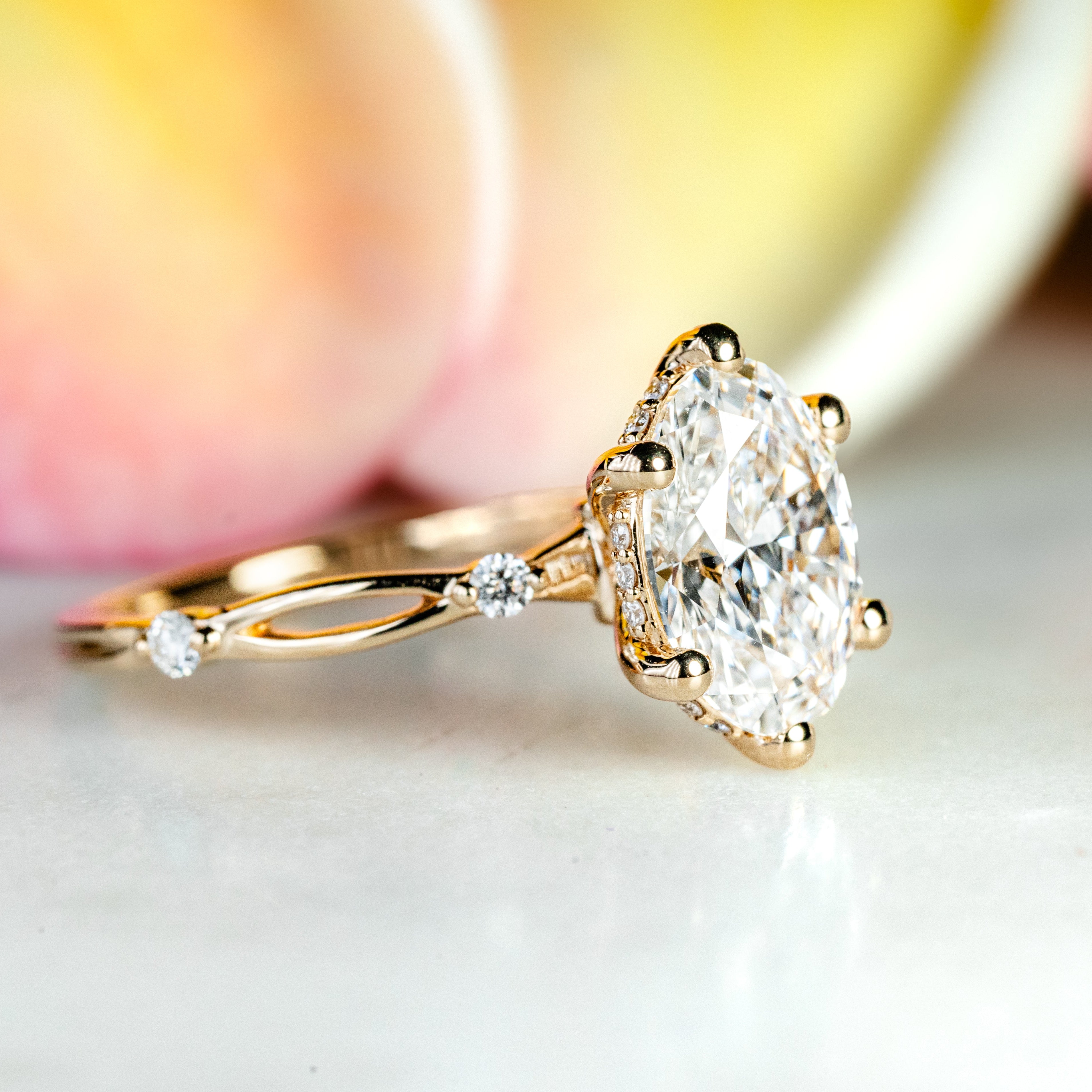 Gold ring with a large diamond on a light background