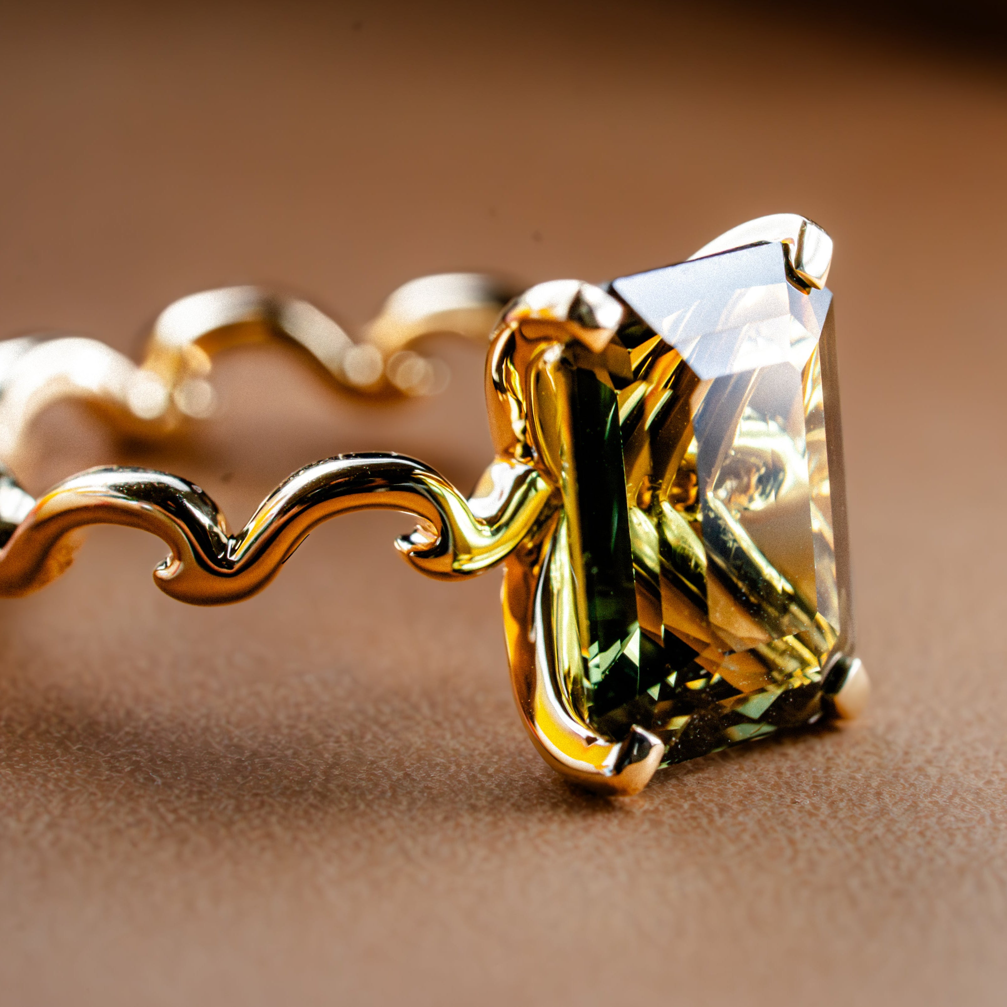 Gold ring with a large gemstone on a brown background