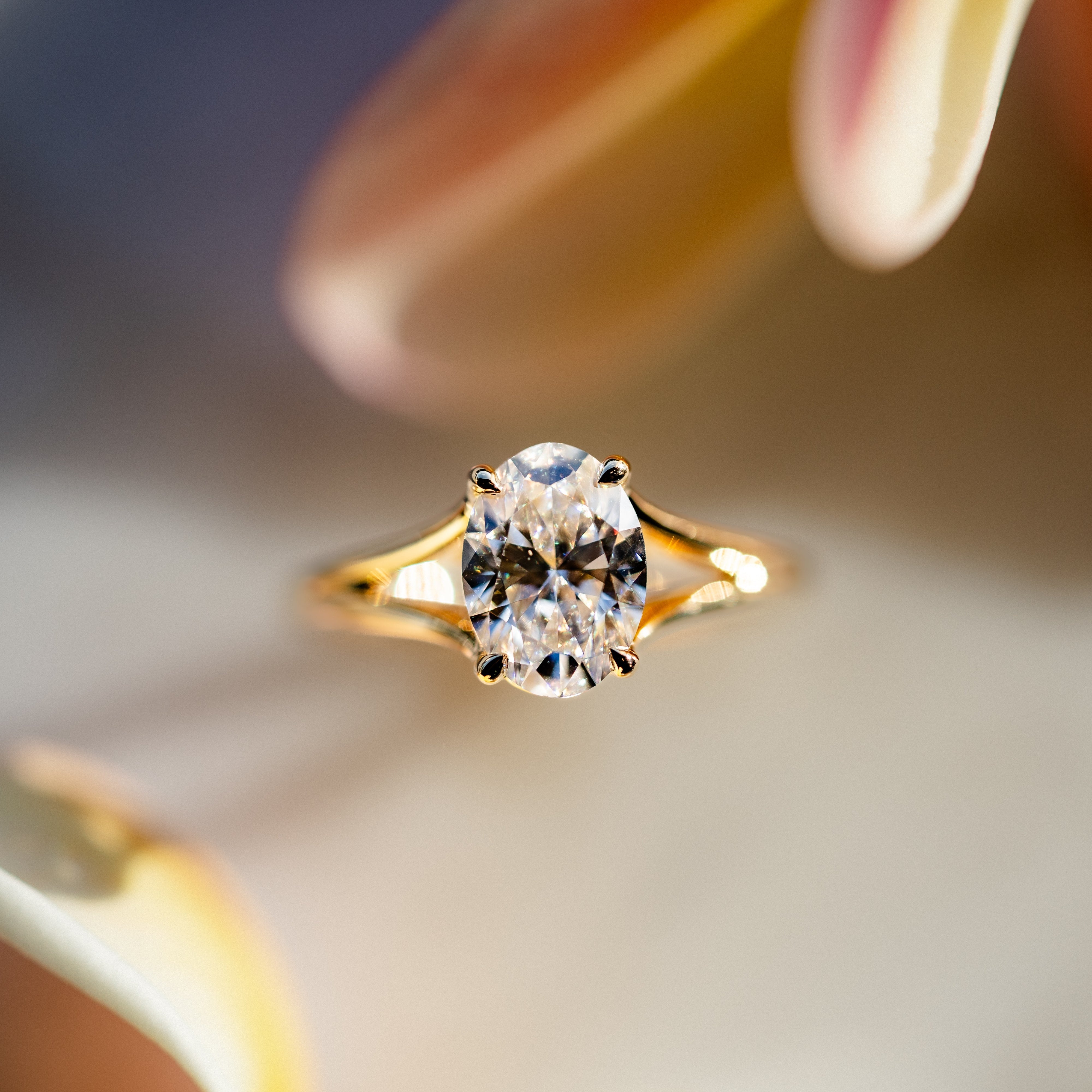Gold ring with a diamond on a blurred background