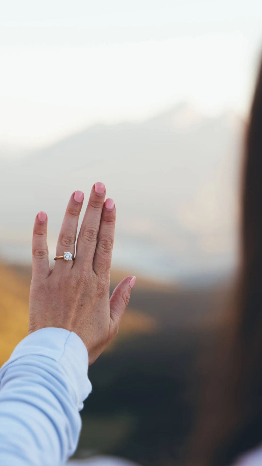 Hand wearing a ring with a blurred background